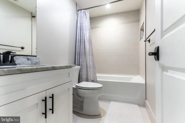 a bathroom with a sink a toilet and a bathtub