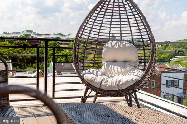 a view of balcony with wooden floor and outdoor seating