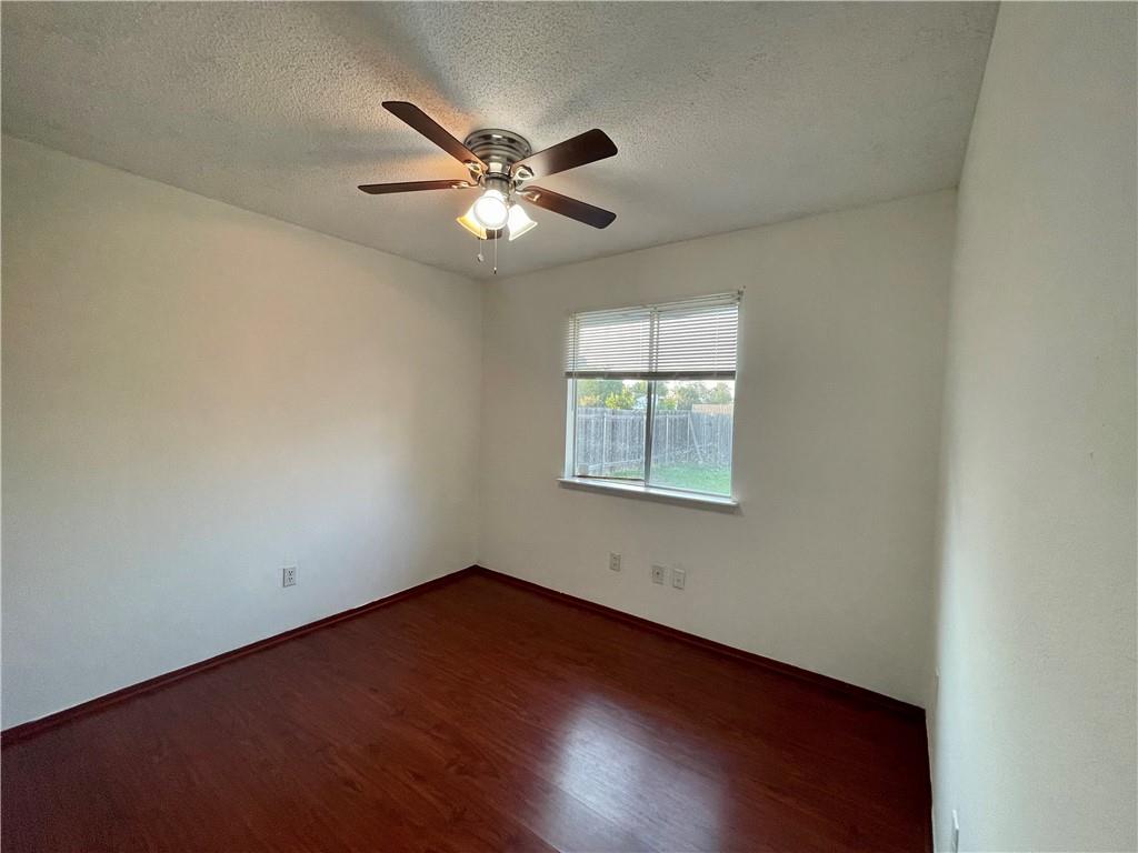16927 Whitebrush Loop Austin, TX 78717 - Photo 12 of 28 an empty room with wooden floor fan and windows