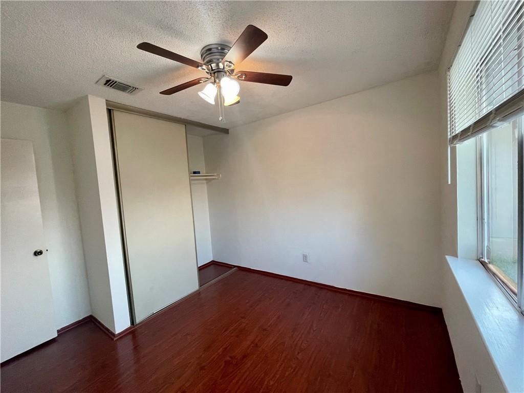 16927 Whitebrush Loop Austin, TX 78717 - Photo 13 of 28 an empty room with wooden floor and fan