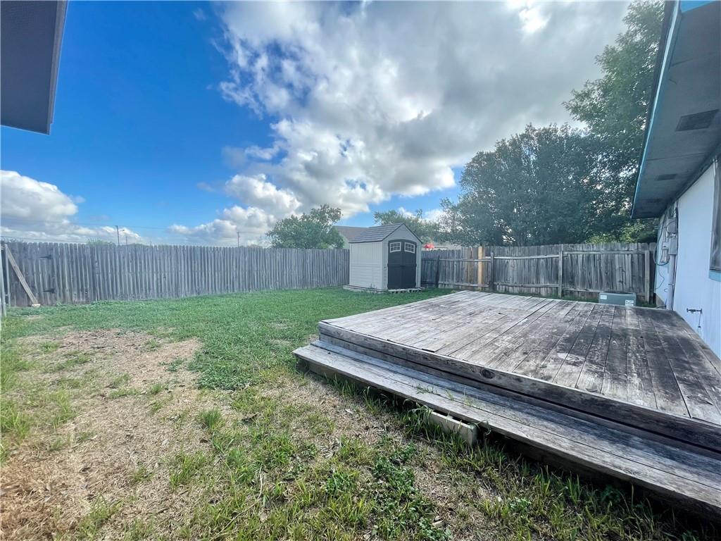 16927 Whitebrush Loop Austin, TX 78717 - Photo 15 of 28 a view of a backyard with a barbeque and wooden fence