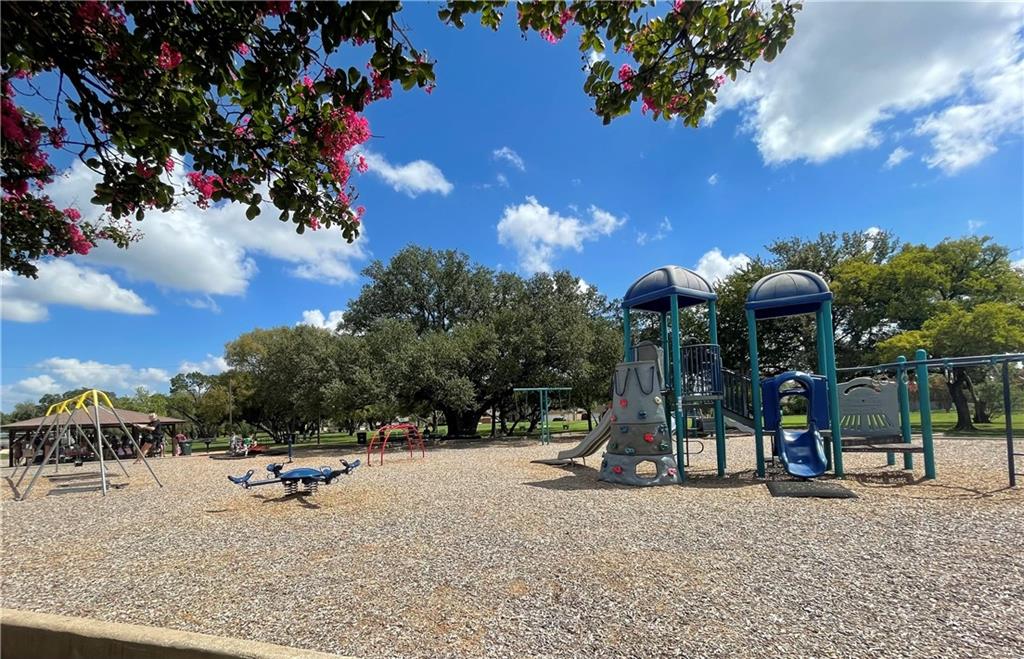 16927 Whitebrush Loop Austin, TX 78717 - Photo 25 of 28 a view of a park with swings and slides