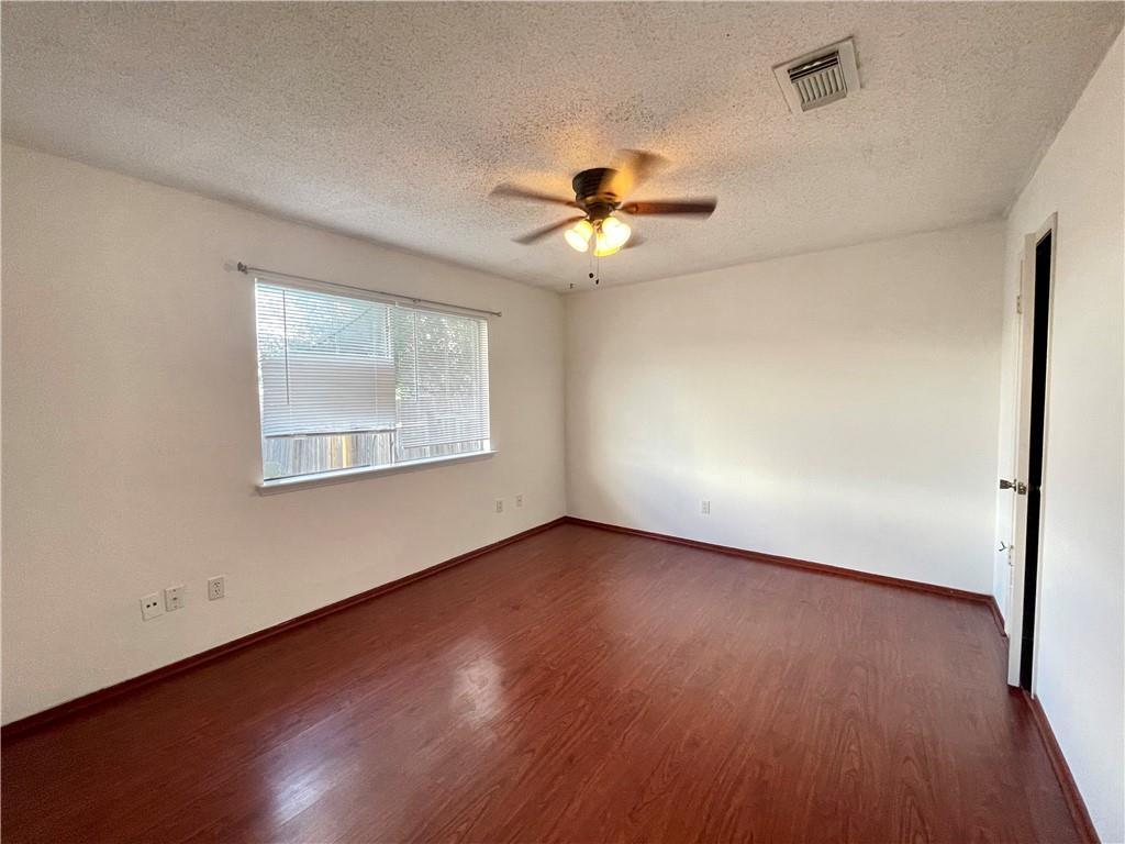 16927 Whitebrush Loop Austin, TX 78717 - Photo 10 of 28 a view of an empty room with wooden floor and a window
