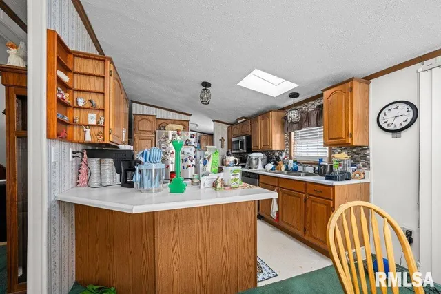 a kitchen with stainless steel appliances granite countertop a sink and cabinets