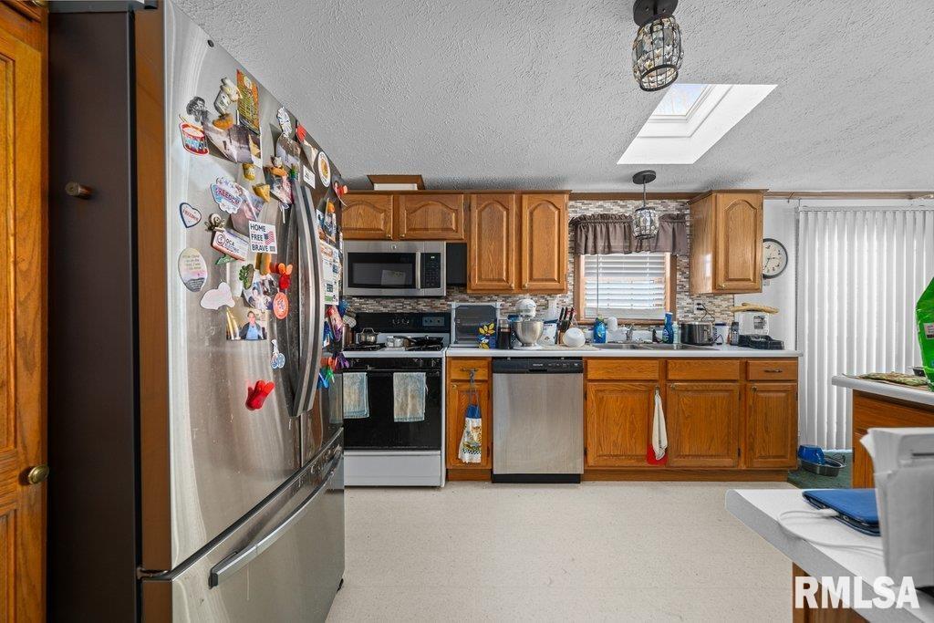 409 233rd Street Aledo, IL 61231 - Photo 18 of 45 a kitchen with stainless steel appliances granite countertop a refrigerator and a sink