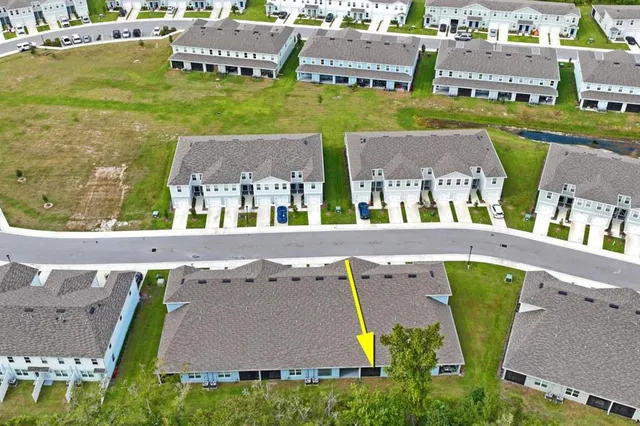 an aerial view of a house with outdoor space