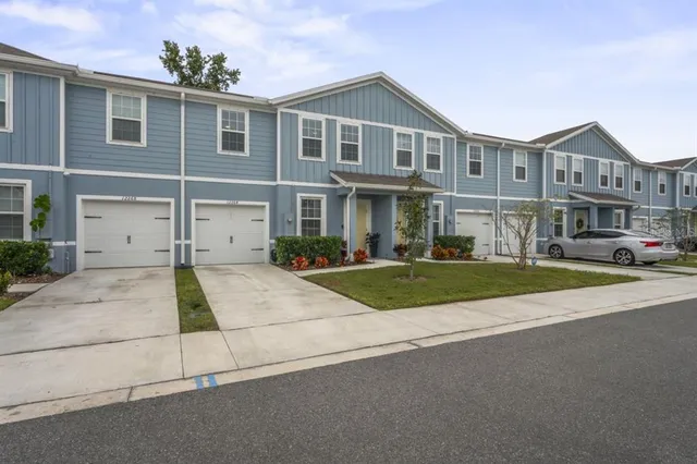 a front view of a house with a yard and garage