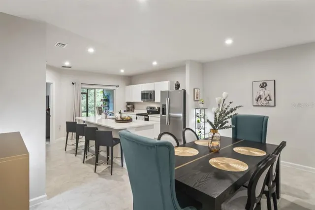 a dining room with furniture and a kitchen view