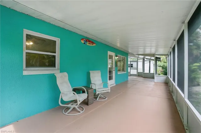 a view of a room with furniture and a window