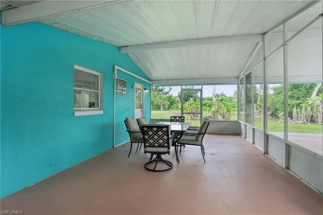 a dining room with furniture and a window