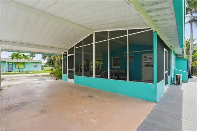 a view of a house with a yard and potted plants