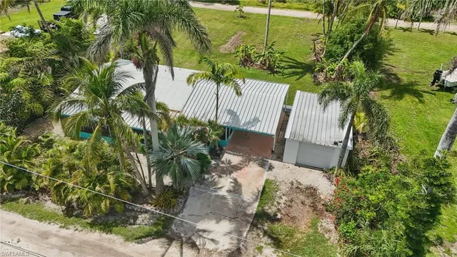 an aerial view of a house with a yard