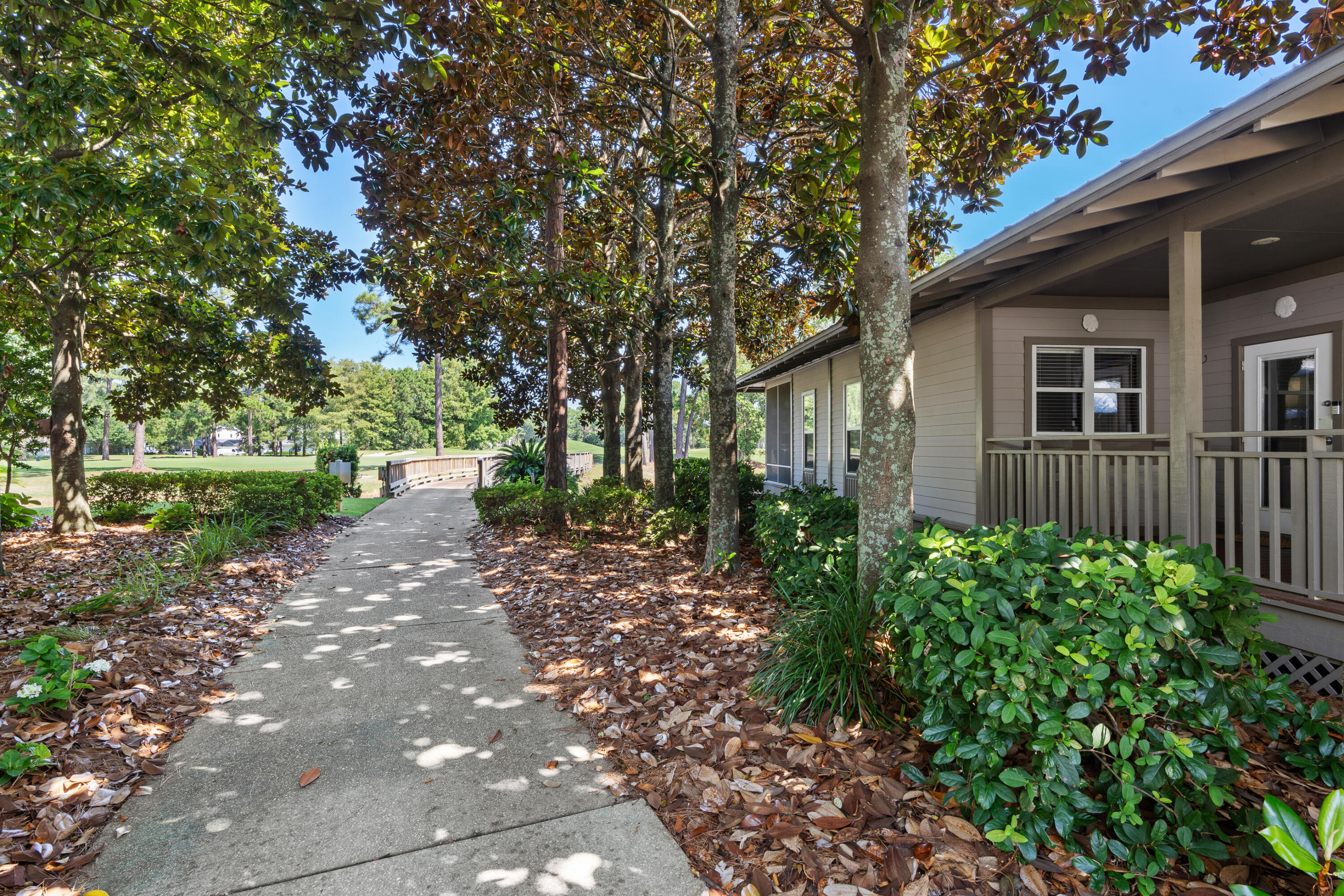 1108 Prestwick Place Miramar Beach, FL 32550 - Photo 36 of 47 a view of a backyard with plants and large trees