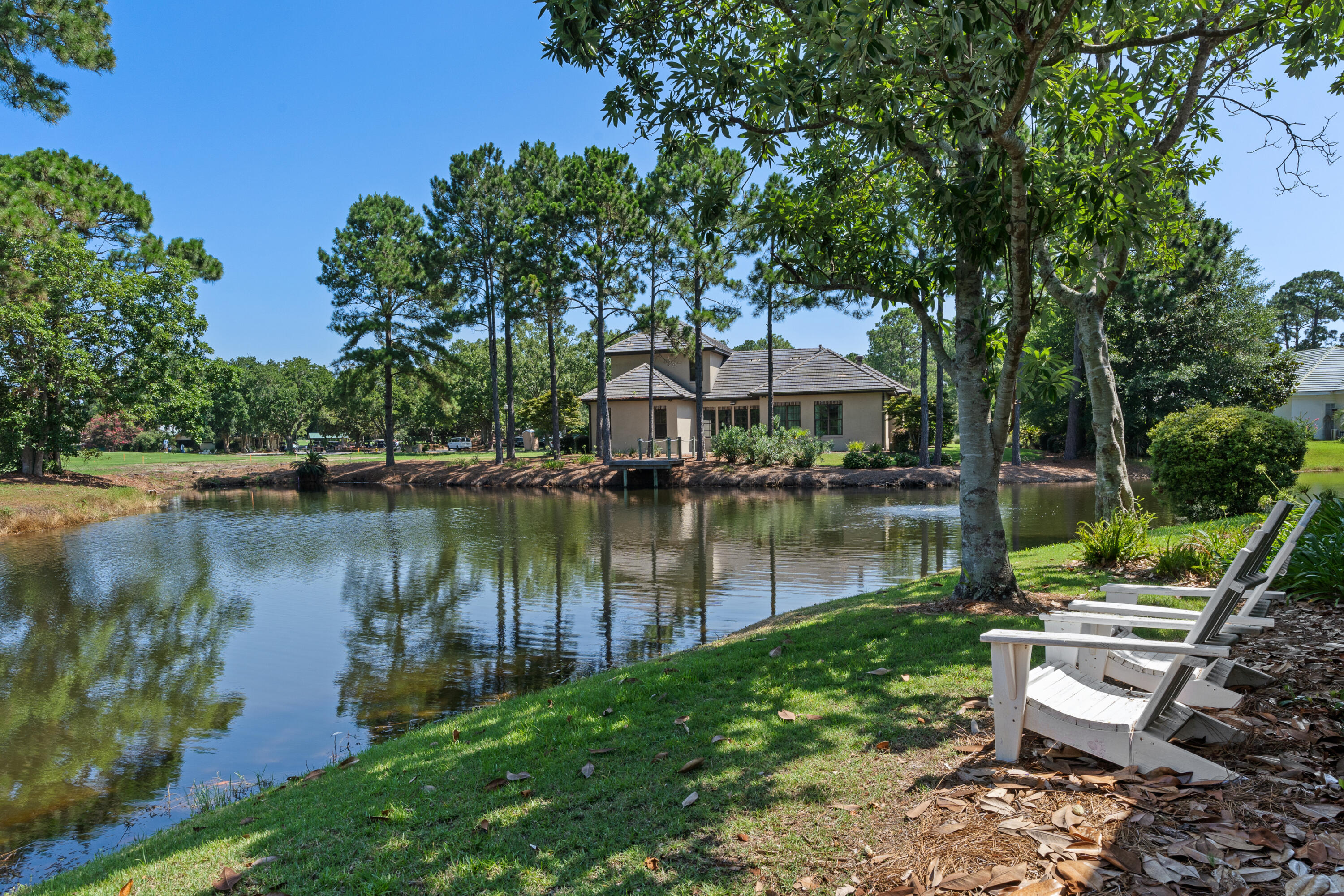 1108 Prestwick Place Miramar Beach, FL 32550 - Photo 41 of 47 a view of a lake with table and chairs under an umbrella