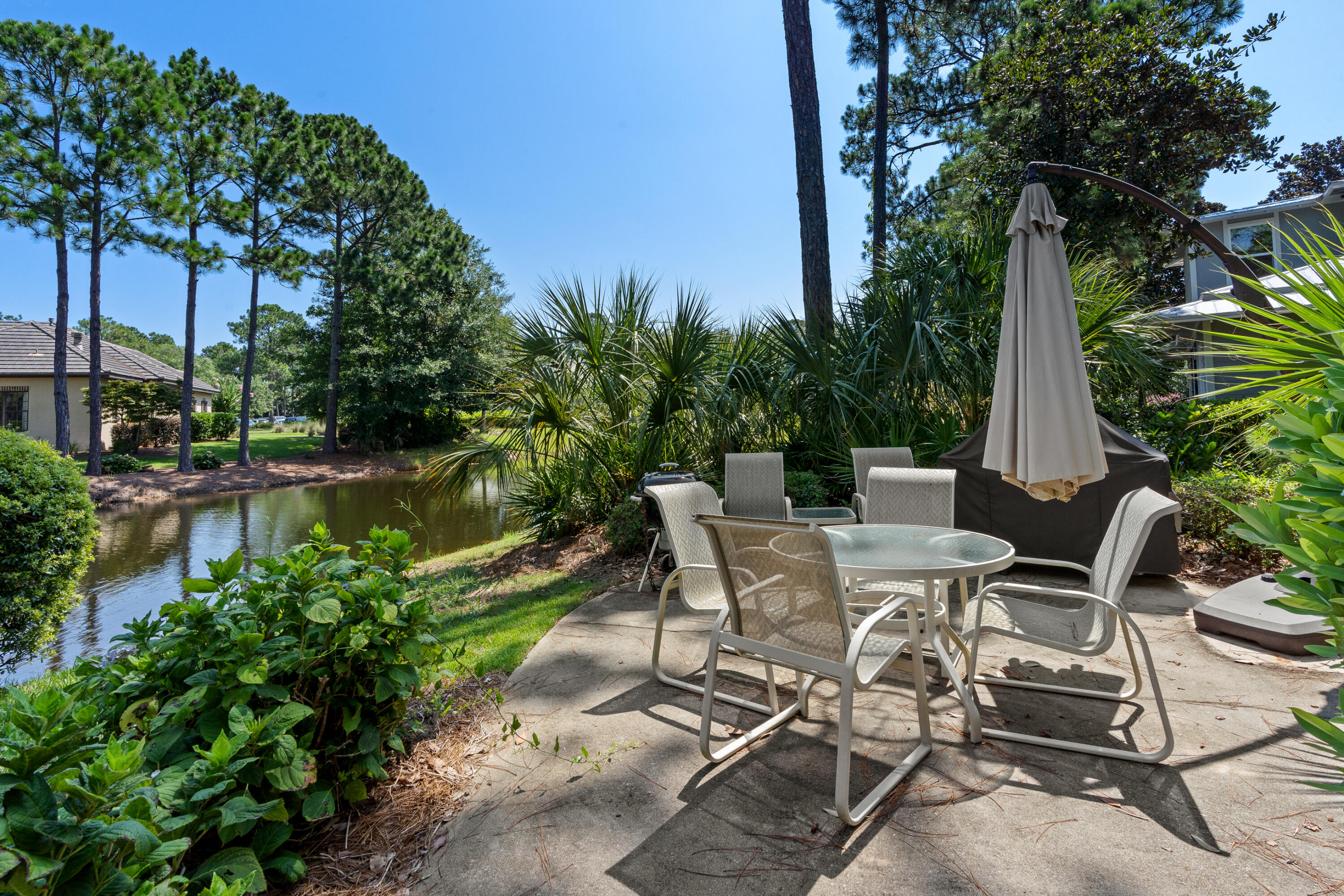 1108 Prestwick Place Miramar Beach, FL 32550 - Photo 43 of 47 a view of a patio with table and chairs and potted plants