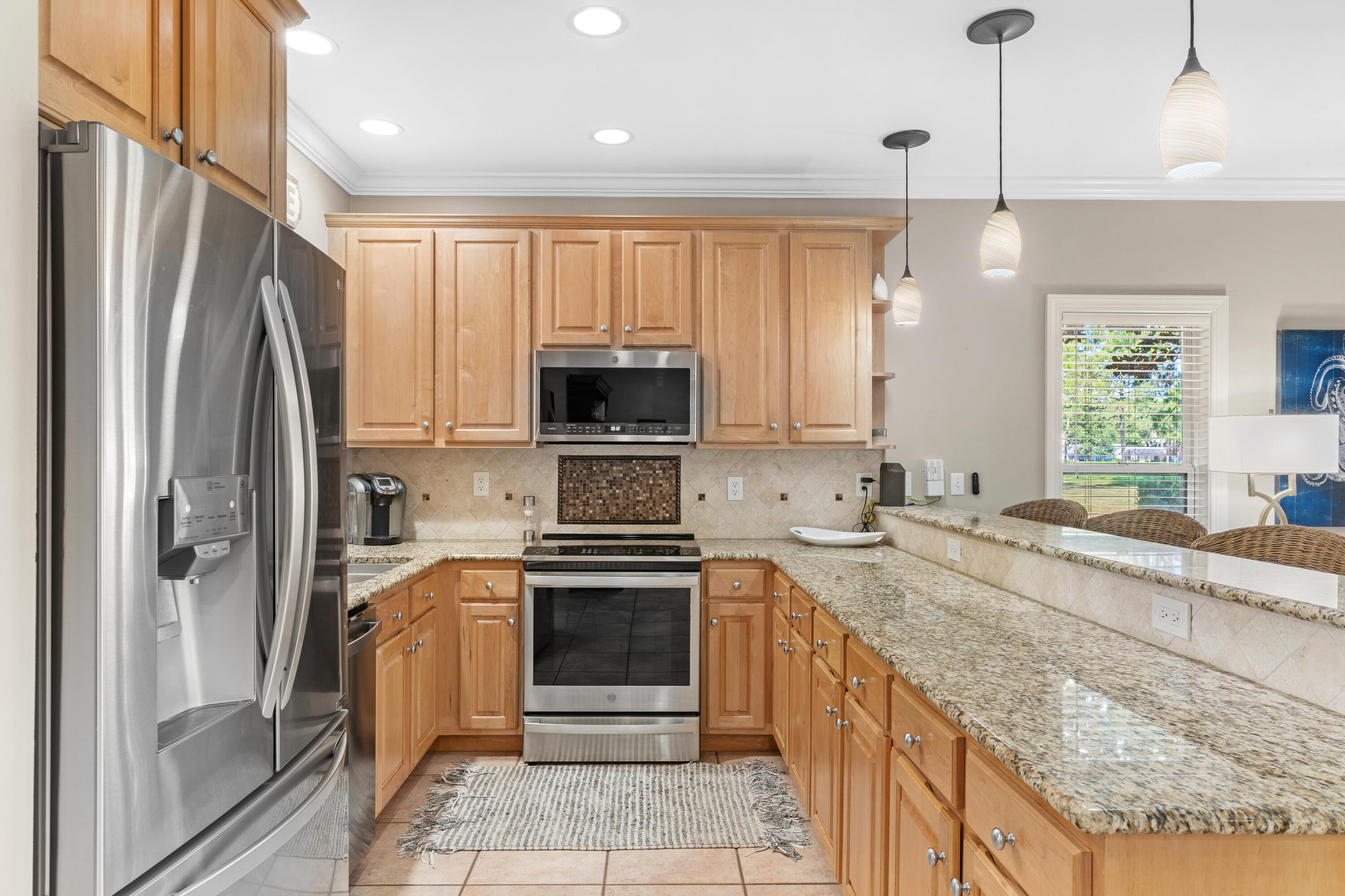 1108 Prestwick Place Miramar Beach, FL 32550 - Photo 10 of 47 a kitchen with stainless steel appliances granite countertop a refrigerator a stove and a sink