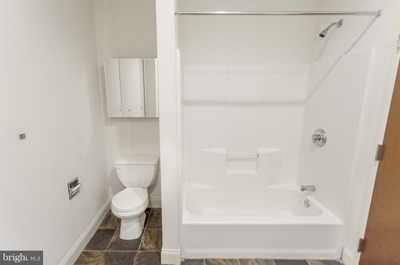 1222-26 Arch Street, Unit 507 Philadelphia, PA 19107 - Photo 4 of 22 a bathroom with a bathtub and a toilet