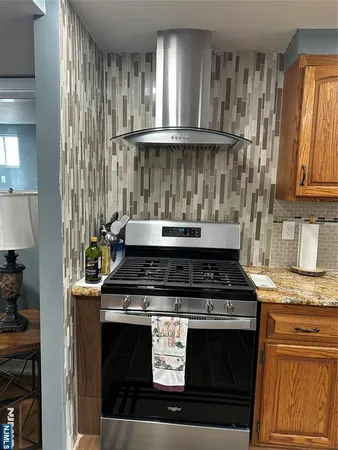 a stove top oven sitting inside of a kitchen