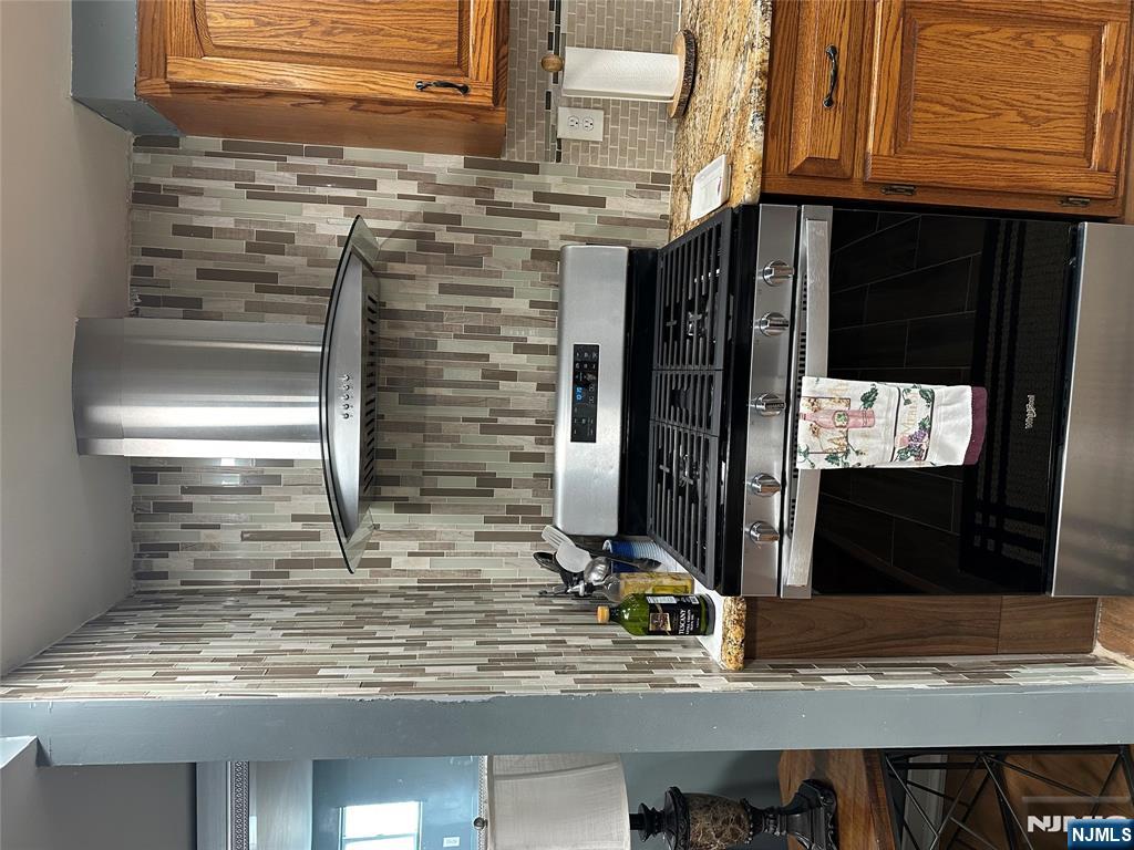 15 2nd Street Lodi, NJ 07644 - Photo 11 of 32 a stove top oven sitting inside of a kitchen
