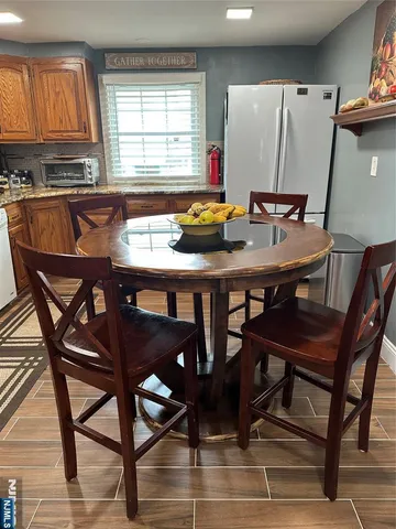 a view of a dining room with furniture and window