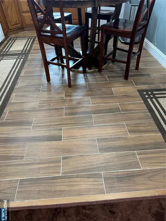 a white bench sitting on top of a wooden floor