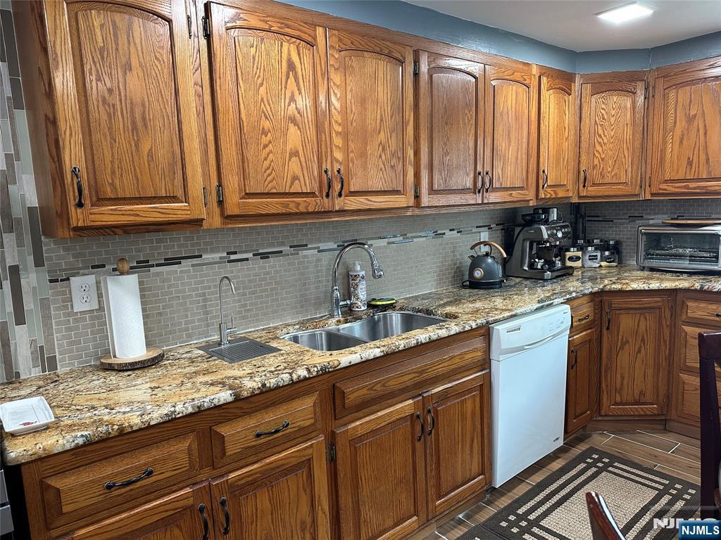 15 2nd Street Lodi, NJ 07644 - Photo 14 of 32 a kitchen with granite countertop stainless steel appliances a sink window and cabinets