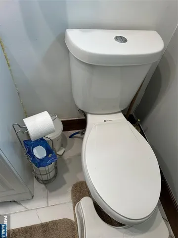 a living room with furniture and a mirror