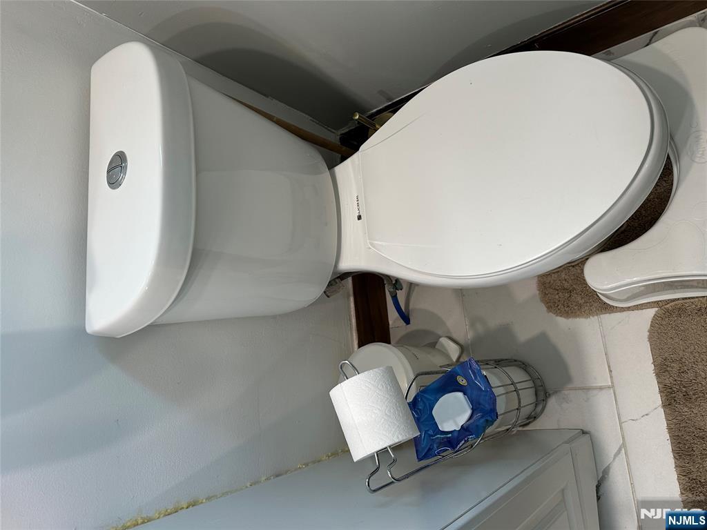 15 2nd Street Lodi, NJ 07644 - Photo 20 of 32 a bathroom with a toilet and a sink