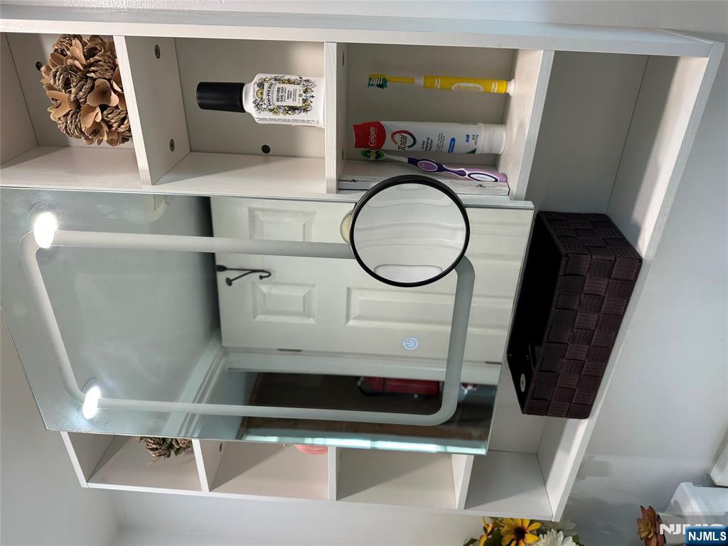 15 2nd Street Lodi, NJ 07644 - Photo 21 of 32 a living room with furniture and a mirror