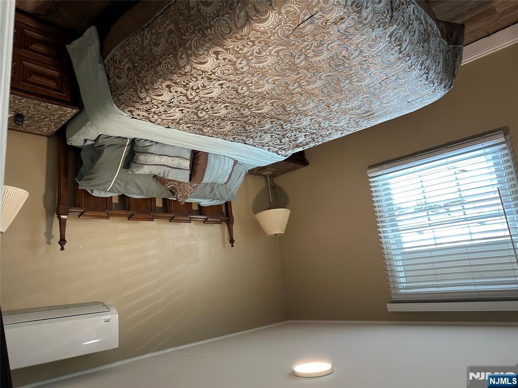 15 2nd Street Lodi, NJ 07644 - Photo 26 of 32 a bed sitting in a bedroom next to a window