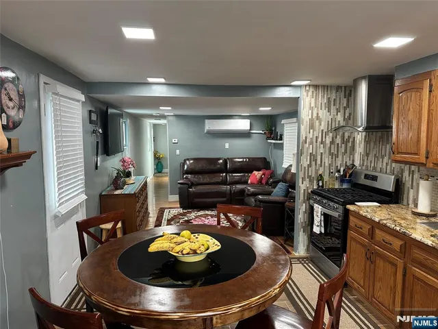 a kitchen with stainless steel appliances kitchen island granite countertop a stove and a sink