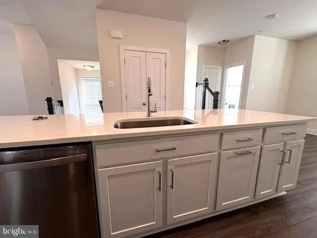 a sink with white cabinets