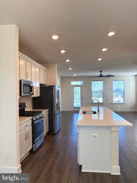 1 Taube Court Owings Mills, MD 21117 - Photo 13 of 36 a kitchen with stainless steel appliances granite countertop a sink refrigerator and microwave