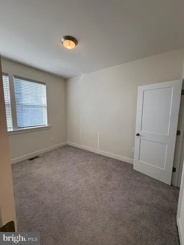 an empty room with a windows and closet
