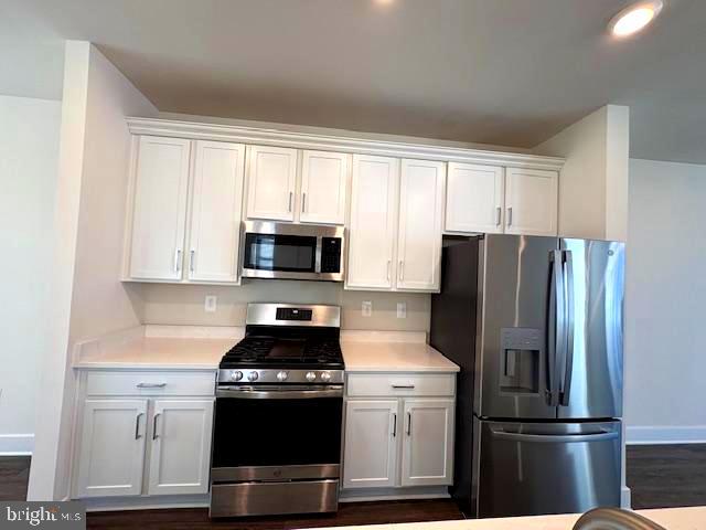 1 Taube Court Owings Mills, MD 21117 - Photo 9 of 36 a kitchen with stainless steel appliances white cabinets and a refrigerator
