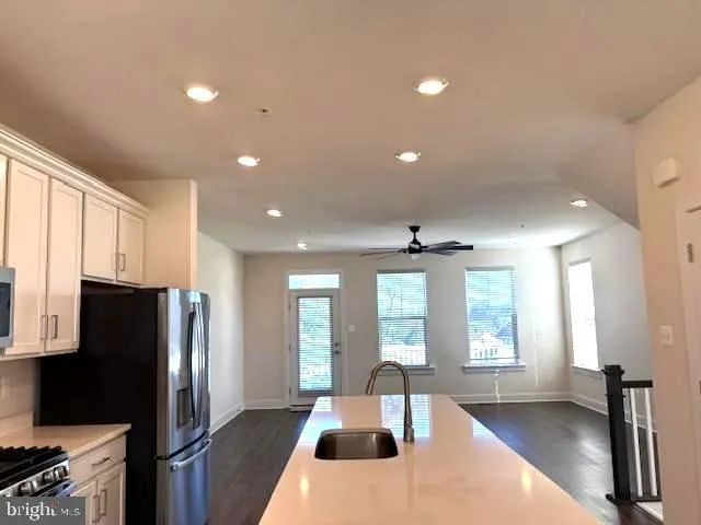 a large kitchen with a large window and stainless steel appliances