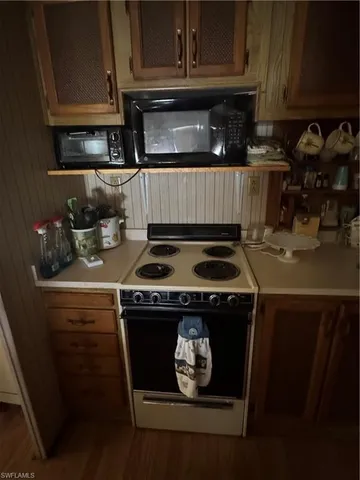 a kitchen with a stove and a microwave