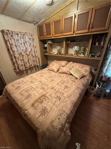 a bed sitting in a bedroom next to a window