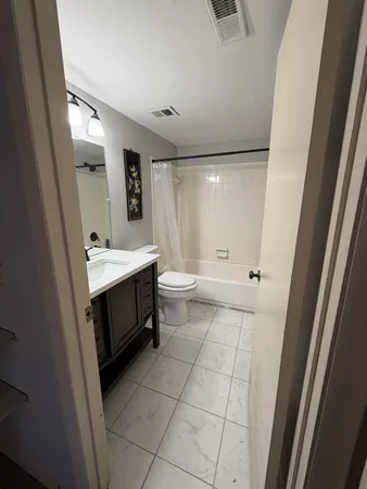 a bathroom with a sink a toilet and mirror