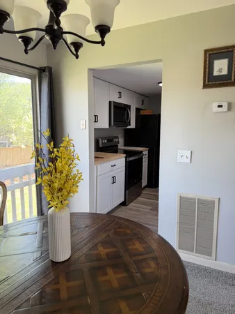 a view of a kitchen with furniture and a potted plant