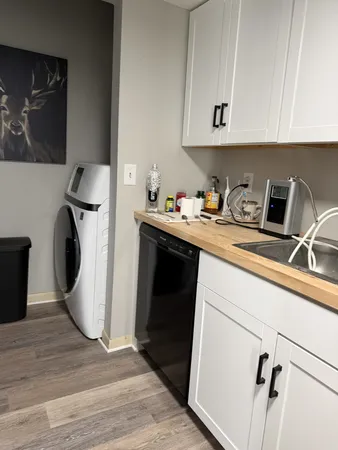 a kitchen with a refrigerator sink and cabinets