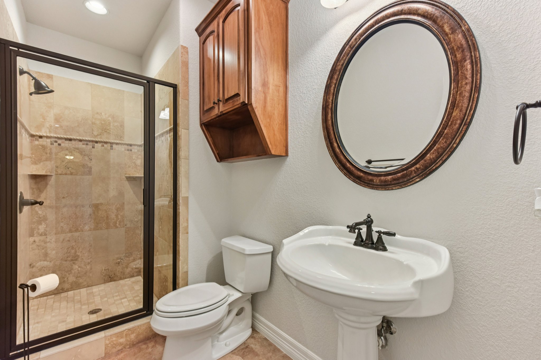 105 Silver Leaf Drive Georgetown, TX 78633 - Photo 11 of 40 a bathroom with a sink a mirror a toilet and a shower
