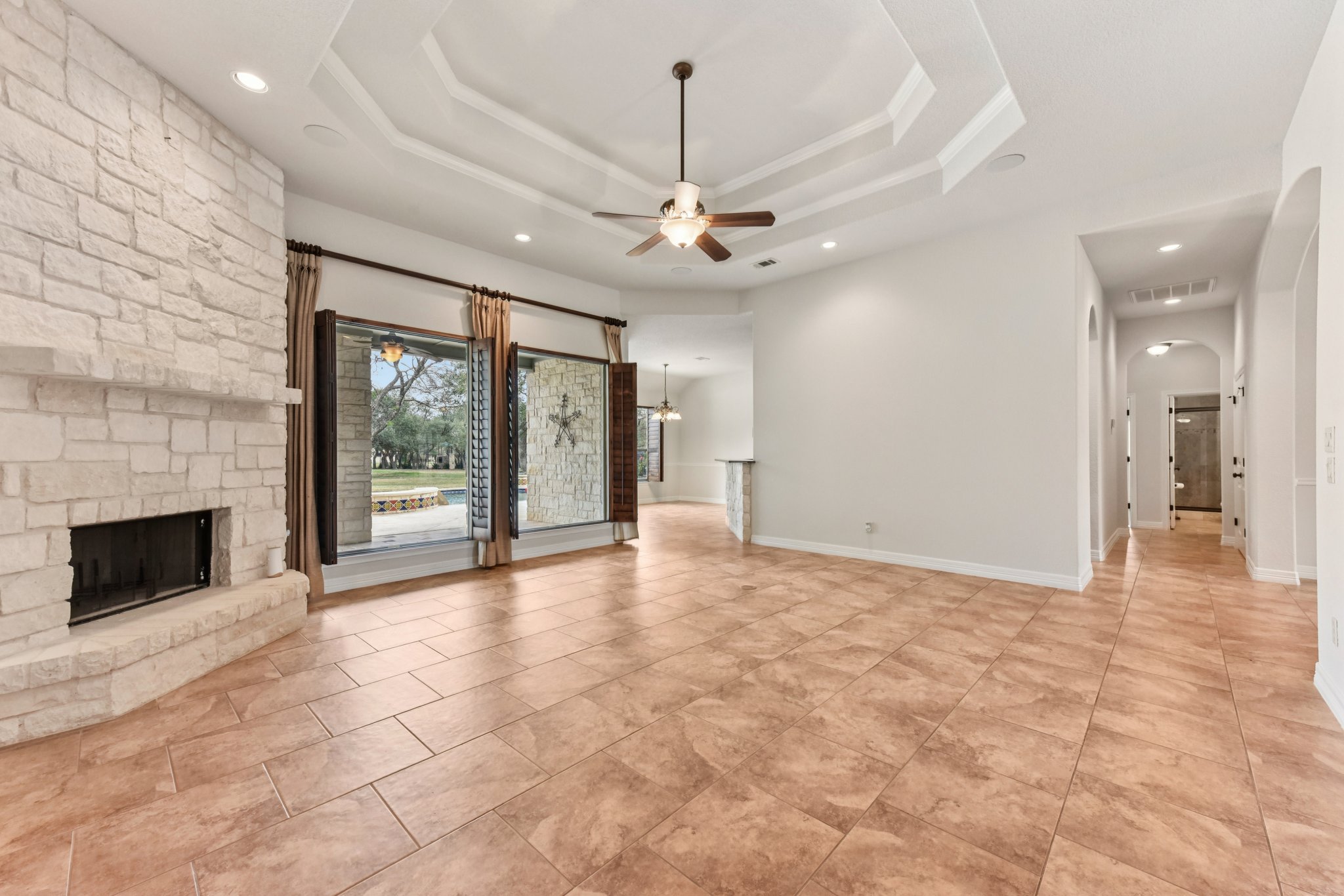 105 Silver Leaf Drive Georgetown, TX 78633 - Photo 6 of 40 a view of an empty room with a fireplace and a chandelier
