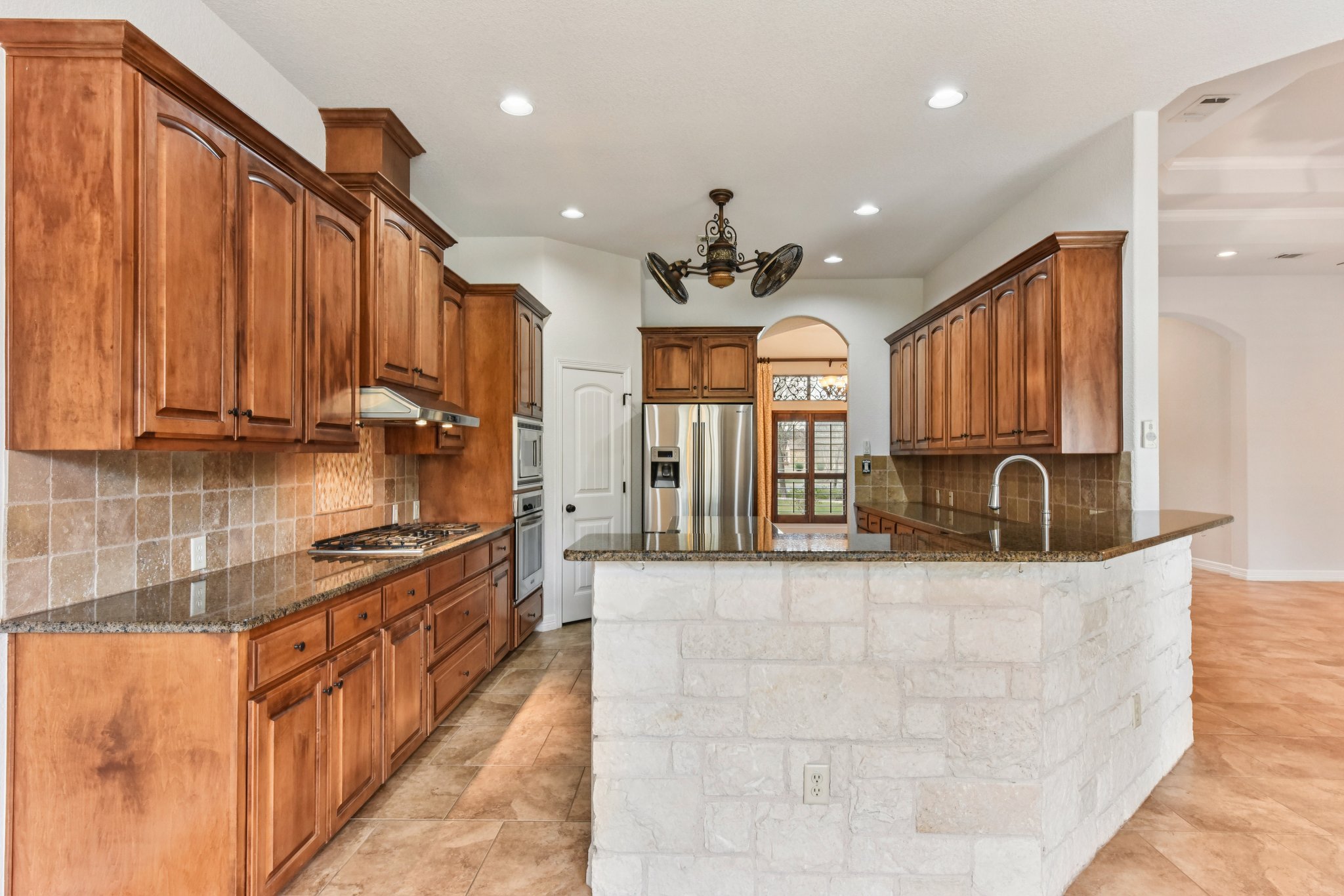 105 Silver Leaf Drive Georgetown, TX 78633 - Photo 7 of 40 a large kitchen with stainless steel appliances granite countertop a sink and cabinets