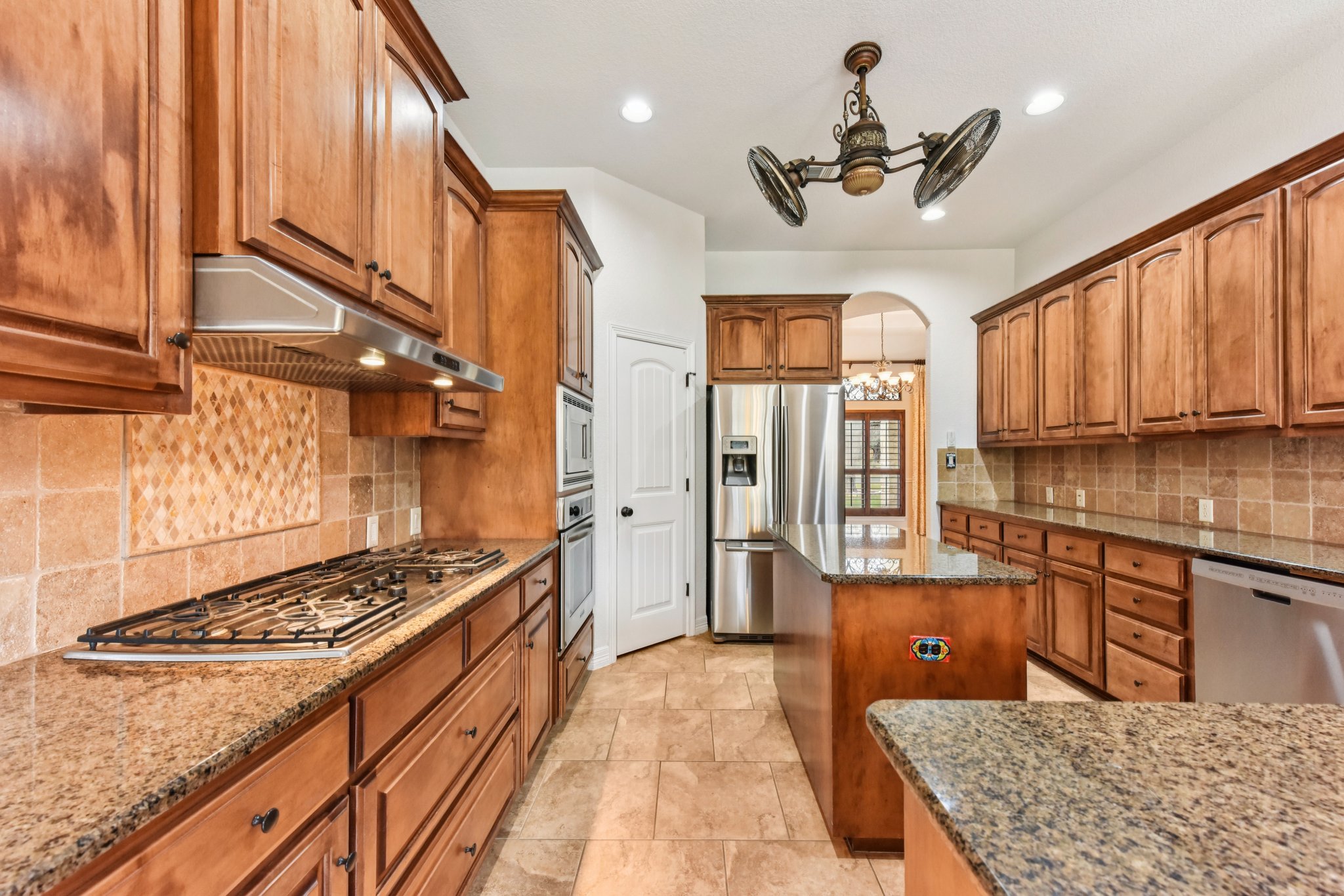 105 Silver Leaf Drive Georgetown, TX 78633 - Photo 8 of 40 a kitchen with stainless steel appliances granite countertop a stove a sink dishwasher and cabinets with wooden floor