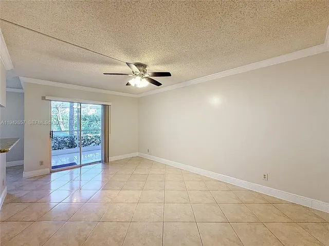 a view of an empty room with a ceiling fan