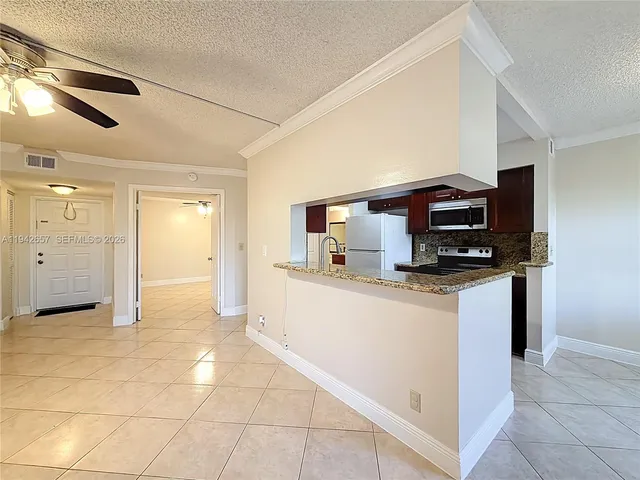 a kitchen with stainless steel appliances granite countertop a sink and a stove