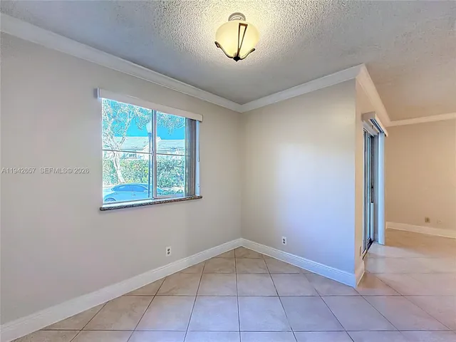 a kitchen with granite countertop a refrigerator and a stove top oven