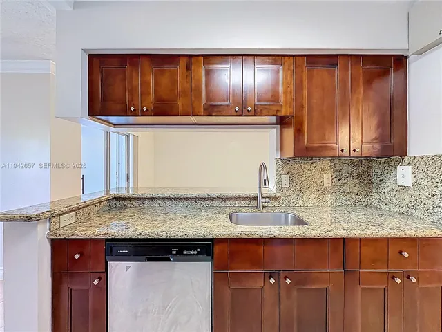 a kitchen with stainless steel appliances granite countertop a stove microwave and refrigerator