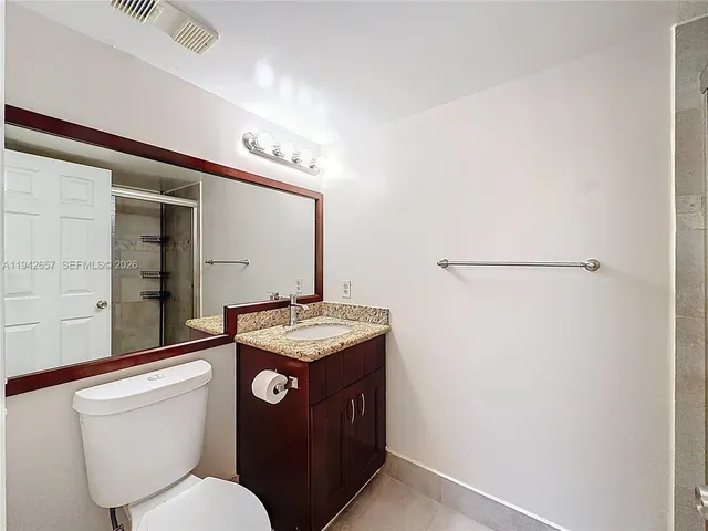 a bathroom with a glass shower door